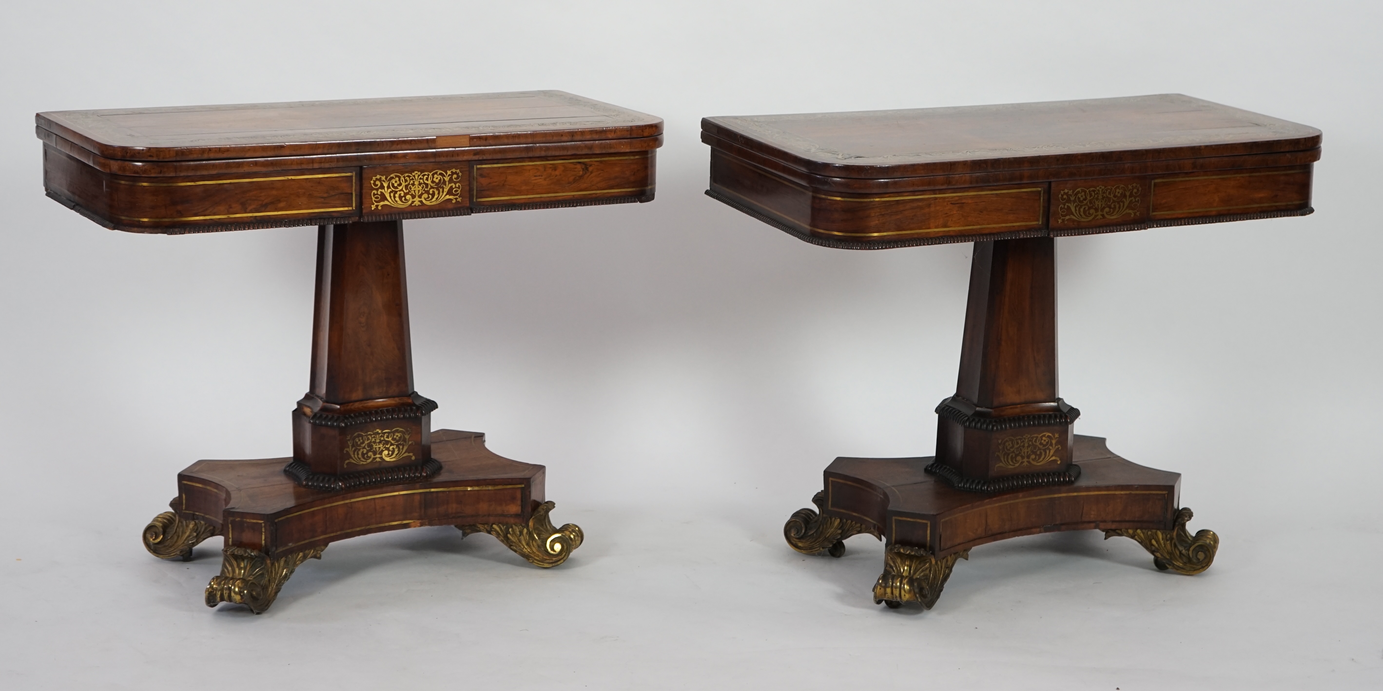 A pair of Regency brass inset rosewood card tables